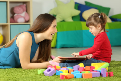 young woman and cute little child playing