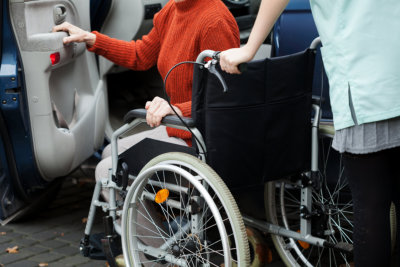 portrait of caregiver and senior woman in a wheelchair